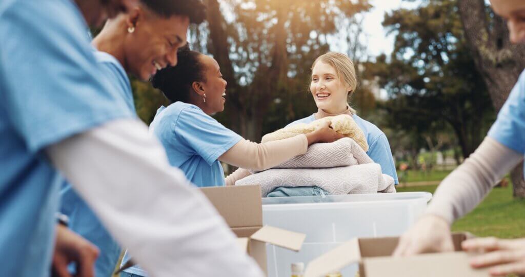 Volunteers sorting donated clothing at an outdoor table
