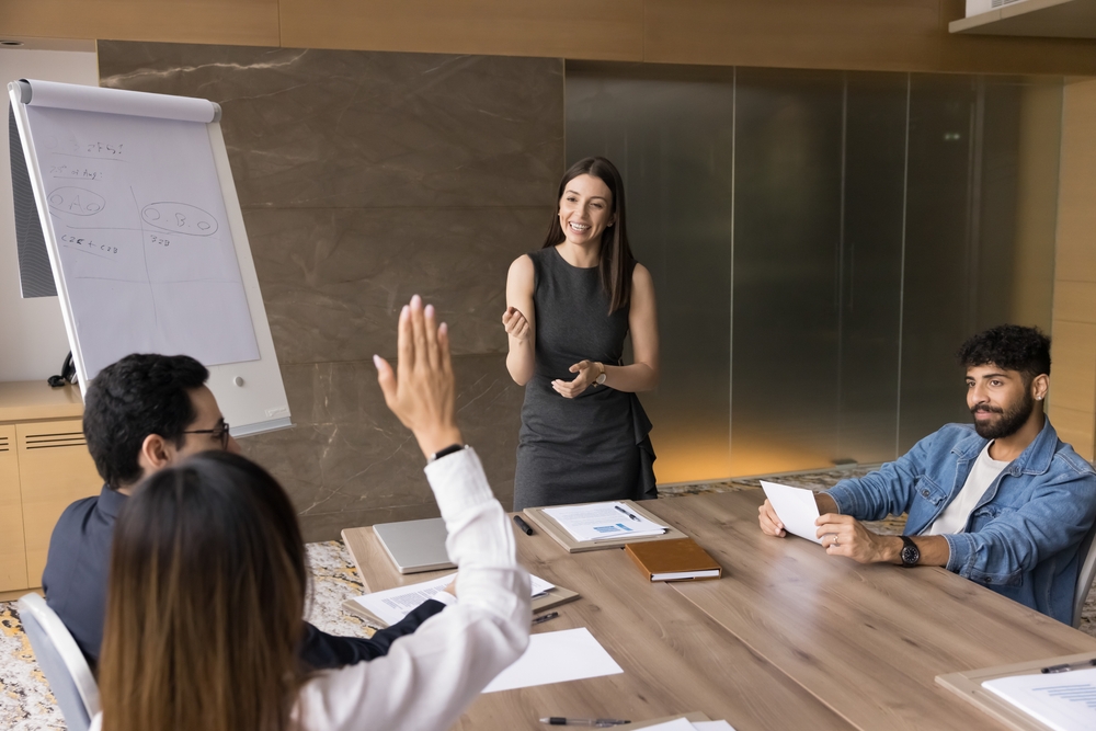 Team participating in a workplace meeting and discussion, representing an employee volunteer program and collaborative employee engagement.