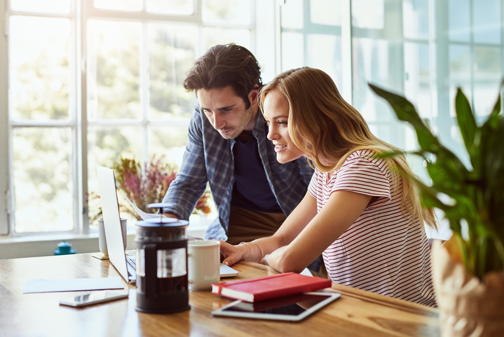 Two people reviewing financial information on a laptop, illustrating accounting for nonprofits and collaborative nonprofit financial management.